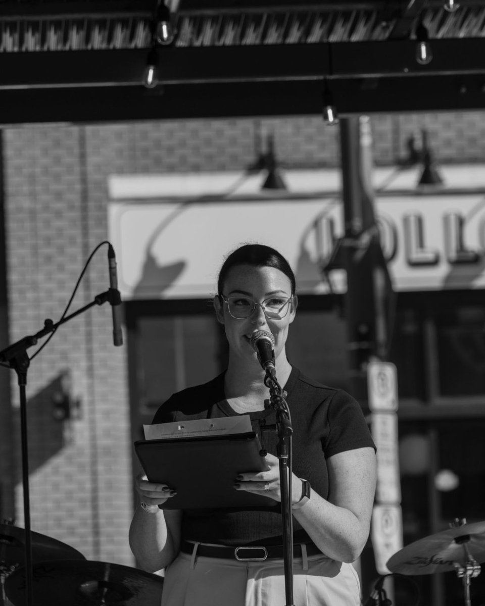 Victoria Williston speaking at a microphone at the Carré ByWard Square opening celebration